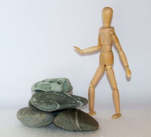 A figure approaches a pile of rocks